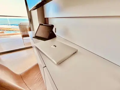a laptop sitting on top of a counter in a room at Beachfront Apartment - Pool - Jacuzzi - Wi-Fi in Cartagena de Indias