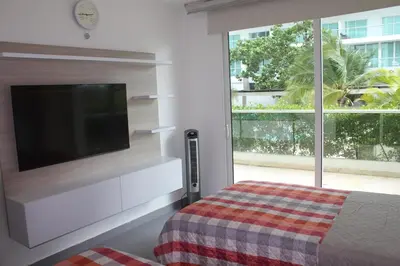 a bedroom with a flat screen tv and a bed at Espectacular apartamento morros 3 in Cartagena de Indias