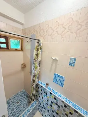 a bathroom with a shower with blue tiles on the wall at Tropical Nomad Hub - Pool - Super Fast Wi-Fi in Santa Veronica