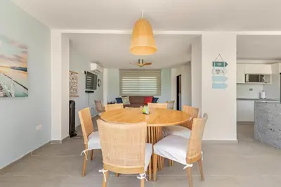 a dining room with a wooden table and chairs at Vacation Home Escape & Villa with pool in El Morro