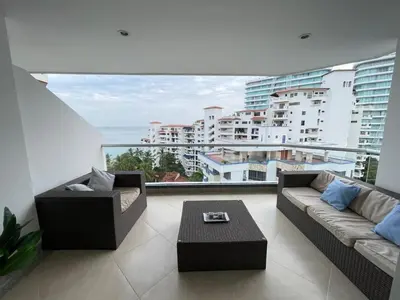 a living room with two couches and a large window at Apartamento con vista al mar en Bello Horizonte, Santa Marta in Santa Marta
