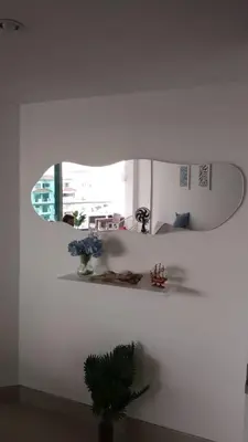 a surfboard hanging on a wall with a shelf at Apartamento con vista al mar en Bello Horizonte, Santa Marta in Santa Marta