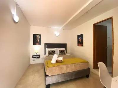 a bedroom with a large bed in a room at Casa Trinidad Getsemaní Hotel in Cartagena de Indias