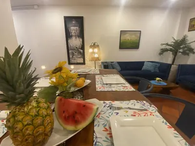 a table with a pineapple and a plate of watermelon at Casa Trinidad Getsemaní Hotel in Cartagena de Indias