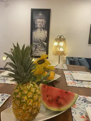 a pineapple and a slice of watermelon on a table at Casa Trinidad Getsemaní Hotel in Cartagena de Indias