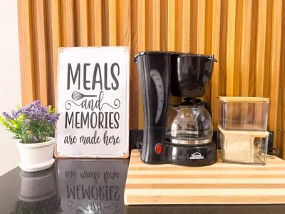 a coffee maker on a counter with a sign at Family apartment in Cartagena 3 bedrooms 2 bathrooms in Cartagena de Indias