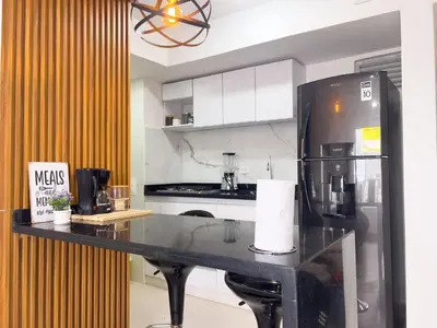 a kitchen with a black counter and a refrigerator at Family apartment in Cartagena 3 bedrooms 2 bathrooms in Cartagena de Indias