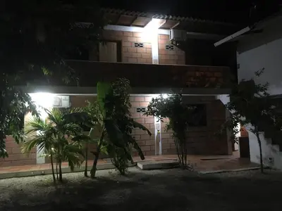 a house at night with trees in front of it at Hotel Pizzeria Opera Tolú in Tolú