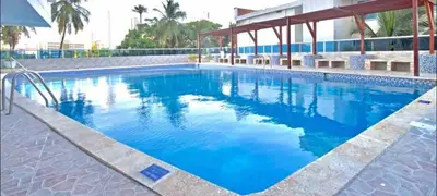 a large swimming pool with blue water at Tu Casa con Vista al Mar , Laguito-Bocagrande in Cartagena de Indias