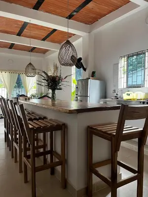 a kitchen with a counter with chairs and a kitchen island at Isla Rosa Coveñas in Coveñitas