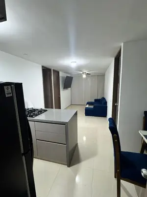 a kitchen and living room with a stove and a couch at Apartamento moderno en zona norte exclusiva in Barranquilla