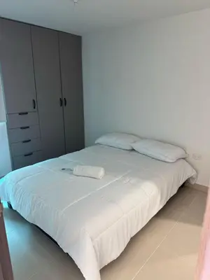 a bedroom with a large white bed with two pillows at Apartamento moderno en zona norte exclusiva in Barranquilla