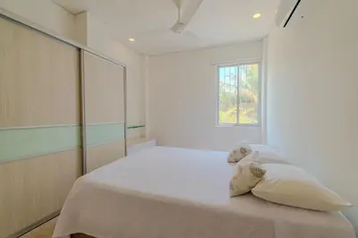 a bedroom with a large bed with a window at Casa Areia Frente Al Mar, Playa Privada in Playa Blanca