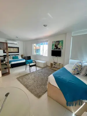 a bedroom with a bed and a tv in it at Cielo mar 202 frente a hotel Las Américas in Cartagena de Indias