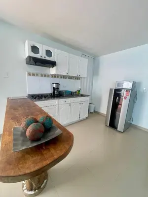 a kitchen with a wooden table and a counter top at Cielo mar 202 frente a hotel Las Américas in Cartagena de Indias