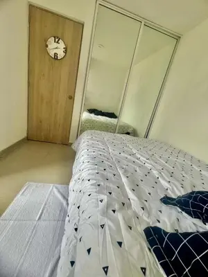 a bedroom with a bed and a clock on the wall at Moderno apartamento con vista al mar en Cartagena in Cartagena de Indias