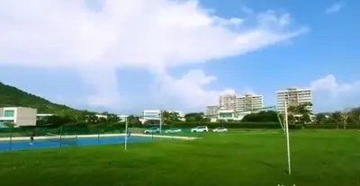a soccer field with buildings in the background at Resort frente al mar in Juan de Acosta