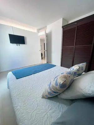 a bedroom with a bed with two pillows on it at Cielo Mar 102 frente a Hotel Las Américas in Cartagena de Indias