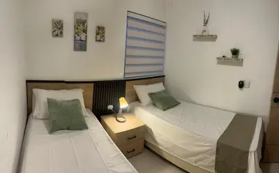 two twin beds in a room with at Beautiful apartment in Cartagena in Cartagena de Indias