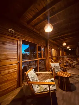 a room with chairs and a table and a window at Rocha Beach Club in Playa Blanca