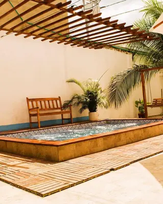 a pool in the middle of a room with a chair at Hb-m8 House With 8 Bedrooms, Pool And Near The Sea in Cartagena de Indias