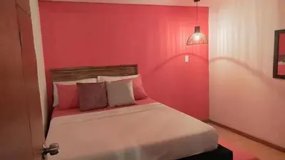 a bedroom with a red wall with a bed at Hb-m8 House With 8 Bedrooms, Pool And Near The Sea in Cartagena de Indias