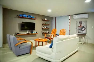 a living room with a white couch and chairs at Cartagena Vibes House in Cartagena de Indias