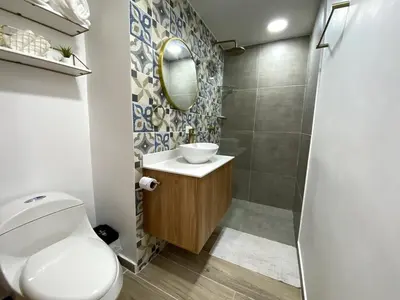 a bathroom with a toilet and a sink and a mirror at Condominio exclusivo Cartagena Beach in Cartagena de Indias