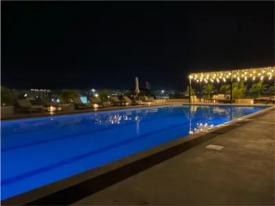 a swimming pool lit up at night with lights at Condominio exclusivo Cartagena Beach in Cartagena de Indias