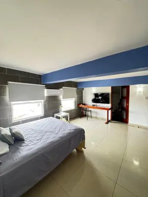 a bedroom with a bed and a table in it at Luxury 2B Duplex in Old City Cartagena in Cartagena de Indias