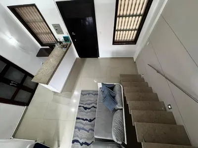 a living room with a couch and a staircase at Luxury 2B Duplex in Old City Cartagena in Cartagena de Indias