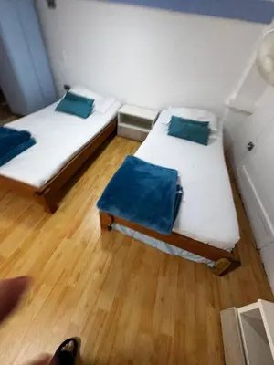 two beds in a room with wooden floors at Luxury Loft in Old City Cartagena - 5th in Cartagena de Indias
