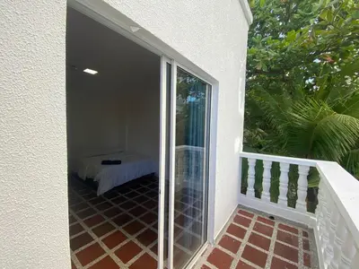 a glass door leading to a balcony with a bed at Hotel Boutique DL in Cartagena de Indias