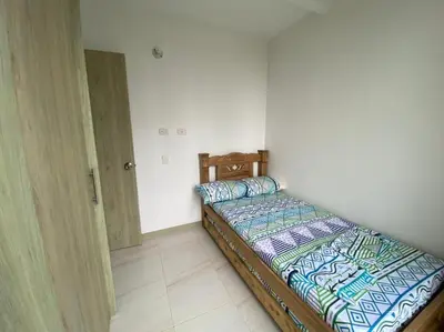 a small bedroom with a bed in a room at Apartamento Playas de Marbella in Cartagena de Indias