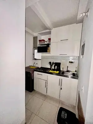 a small kitchen with white cabinets and a sink at Apartamento Playas de Marbella in Cartagena de Indias