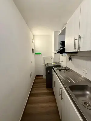 a small kitchen with a sink and a stove at Casa Ingrid in Cartagena de Indias