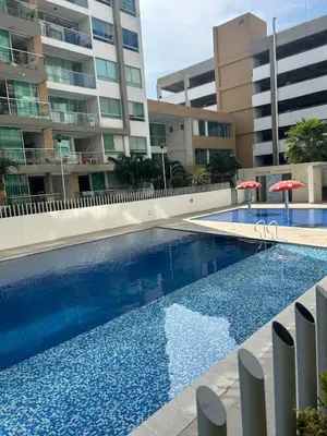 a large swimming pool in front of a building at Confortable Apartamento in Barranquilla