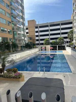 a large swimming pool in front of a building at Confortable Apartamento in Barranquilla