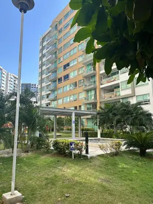 a tall building with a street light in a park at Confortable Apartamento in Barranquilla