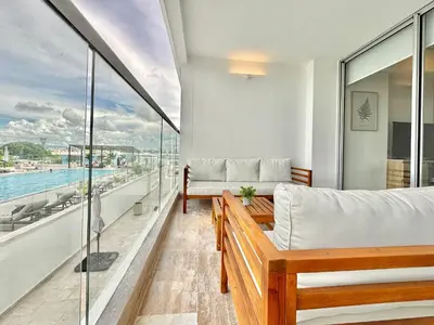 a balcony with a bed and a couch at Suite Familiar + Piscinita + Vista Piscina CB536 in Cartagena de Indias