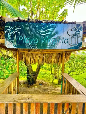 a sign for a play watermill on a wooden fence at Playa Virginia Beach House Privada in San Silvestre