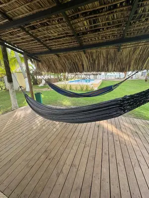 a hammock on a deck in a pavilion at Playa Virginia Beach House Privada in San Silvestre