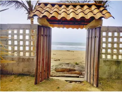 a gate on a beach with the ocean in the background at Tu paraíso frente al mar te espera en Santa Verónica in Tubará