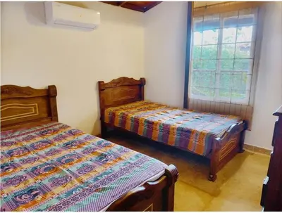 two beds sitting in a room with a window at Tu paraíso frente al mar te espera en Santa Verónica in Tubará