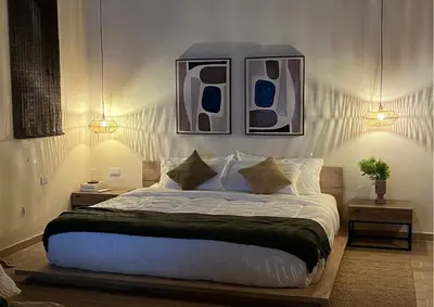 a bedroom with a large bed with two night stands at Villa CANGGU- Villa con piscina privada, estilo mediterraneo in Tubará