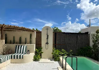 a patio with a bench and a swimming pool at Villa CANGGU- Villa con piscina privada, estilo mediterraneo in Tubará