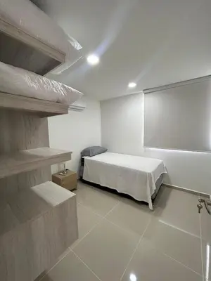 a bedroom with a bed and a large screen at Modern Apartment in Barranquilla in Barranquilla