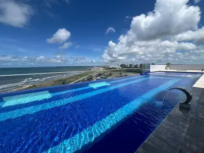 a swimming pool on top of a building next to the ocean at ocean drive magnifica vista y piscina in Cartagena de Indias