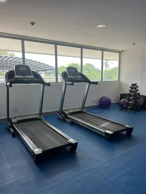 a gym with two treadmills in a room at ocean drive magnifica vista y piscina in Cartagena de Indias