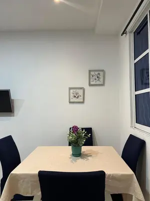 a dining room table with a vase of flowers on it at Tu casa en cartagena in Cartagena de Indias
